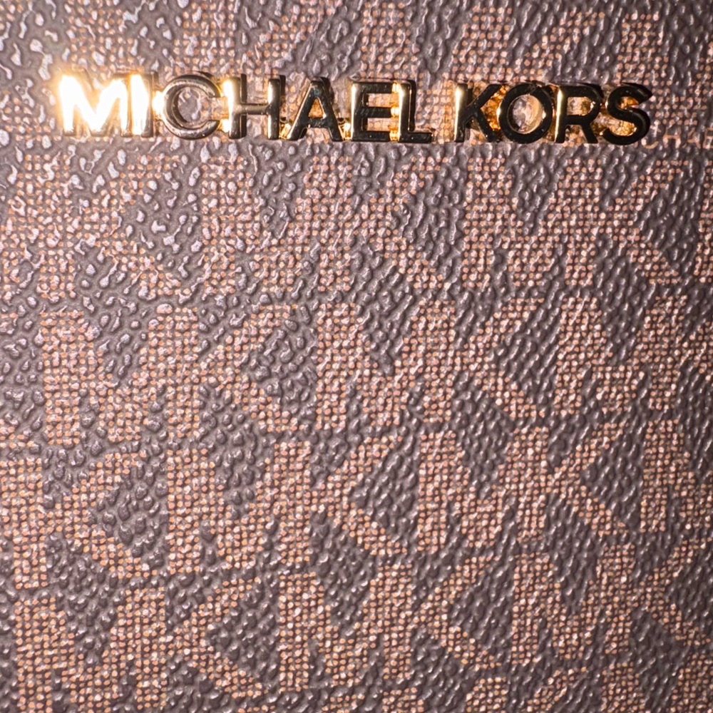Never carried. Been displayed only. Michael Kors crossbody NWOT. Has card card.